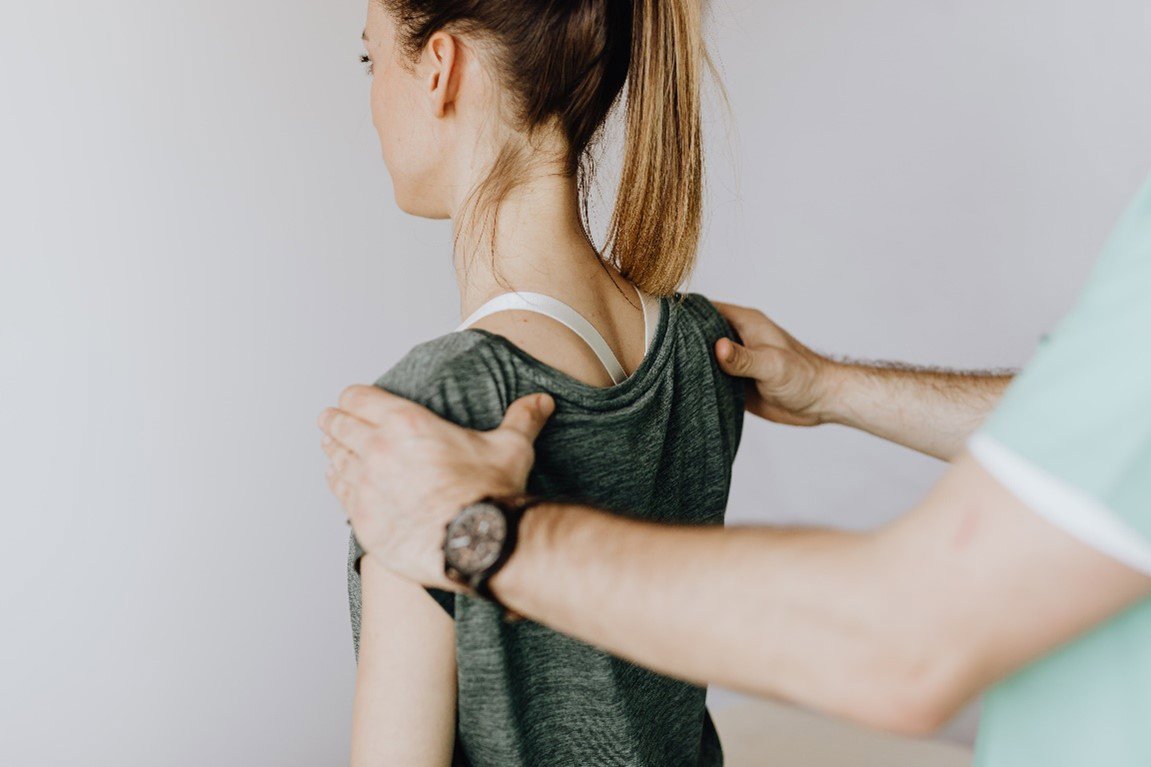 man holding woman's shoulders