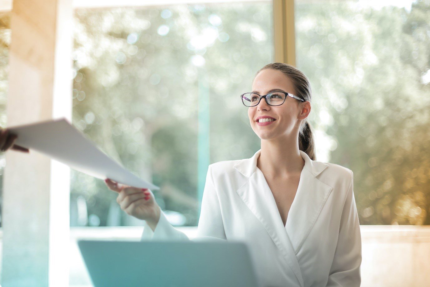 a professional woman handing over documentation