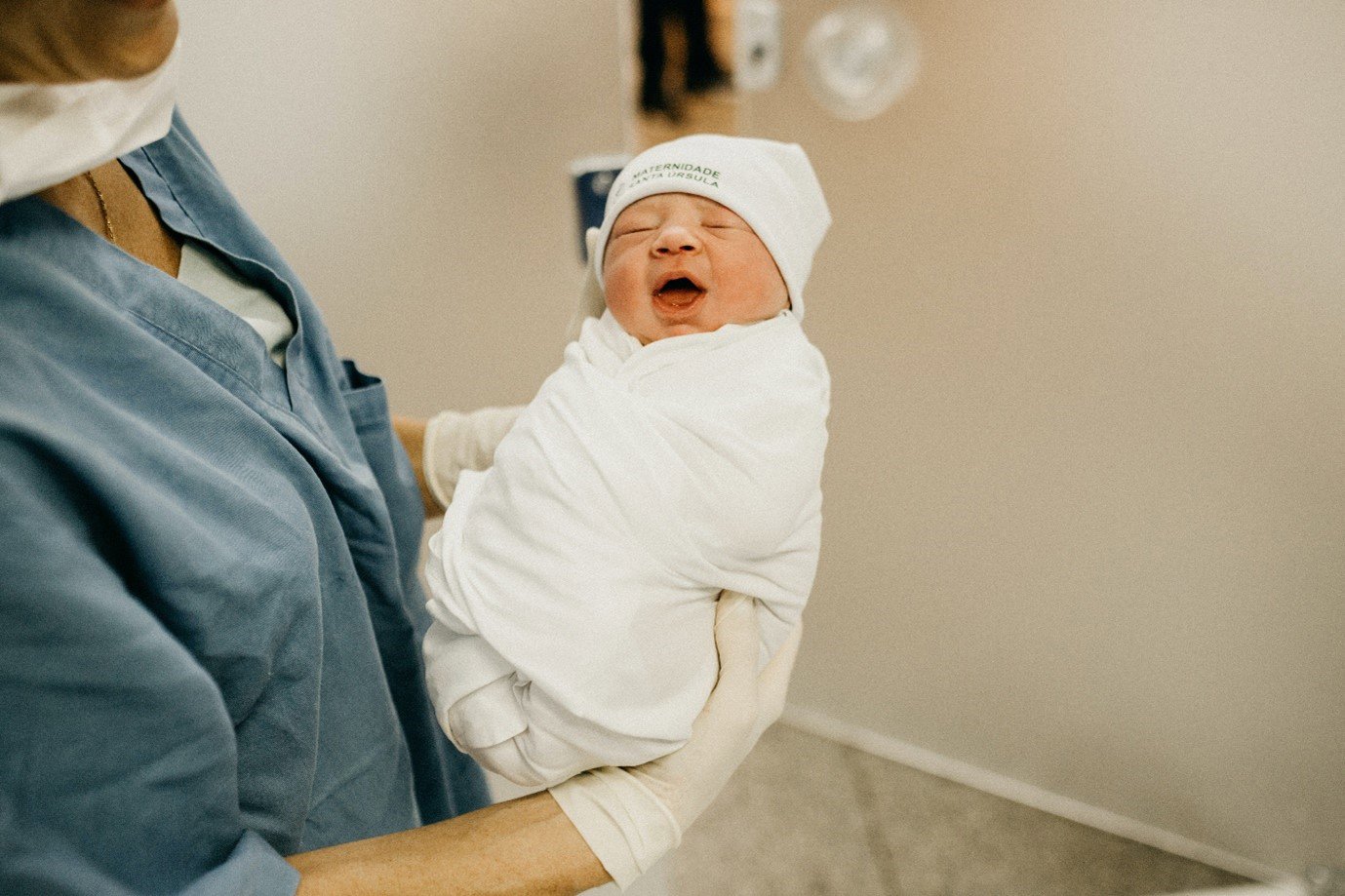 a nurse holding a newborn baby