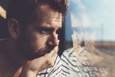 Sad Man Looking Through Window