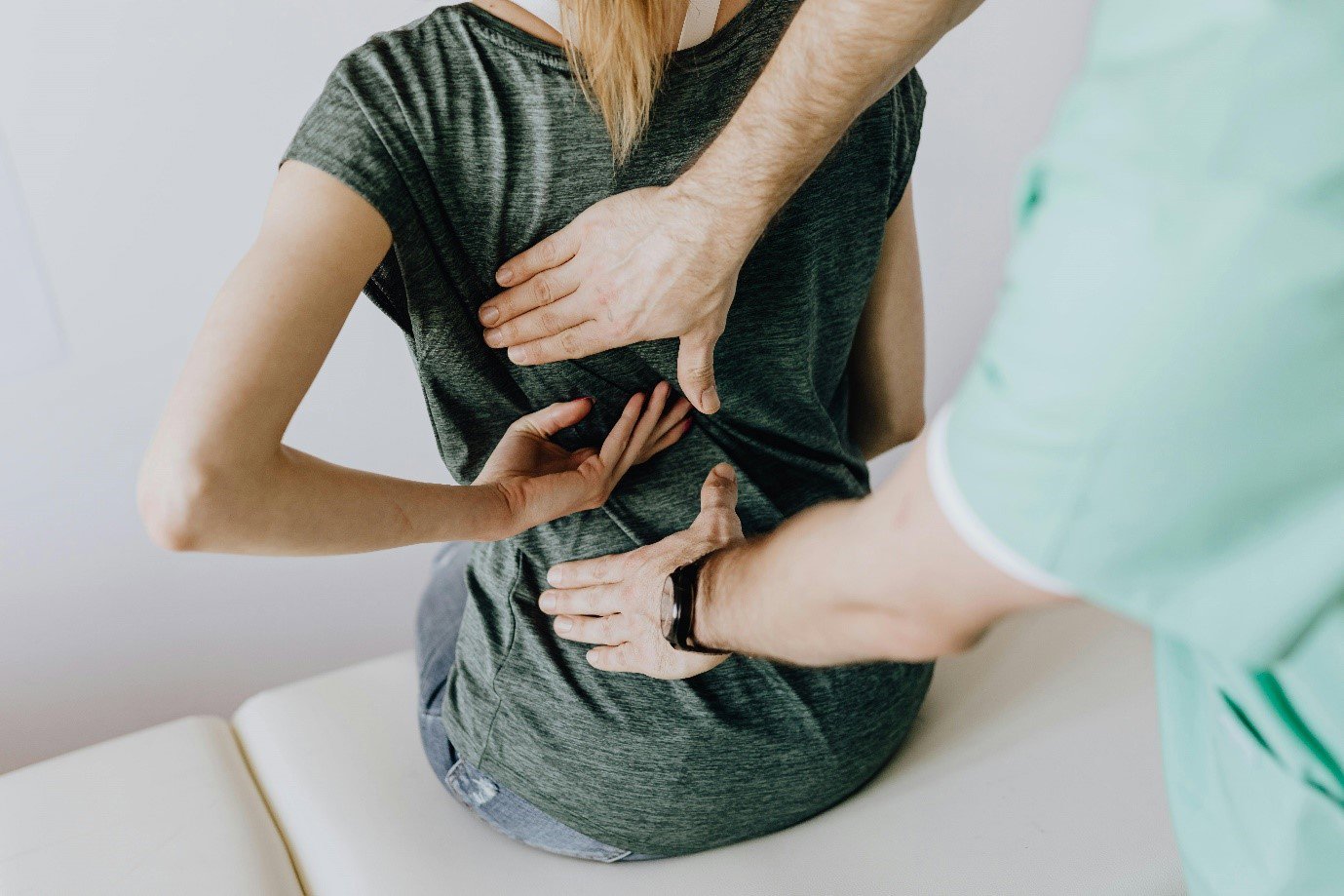 a man performing physiotherapy on a woman's back