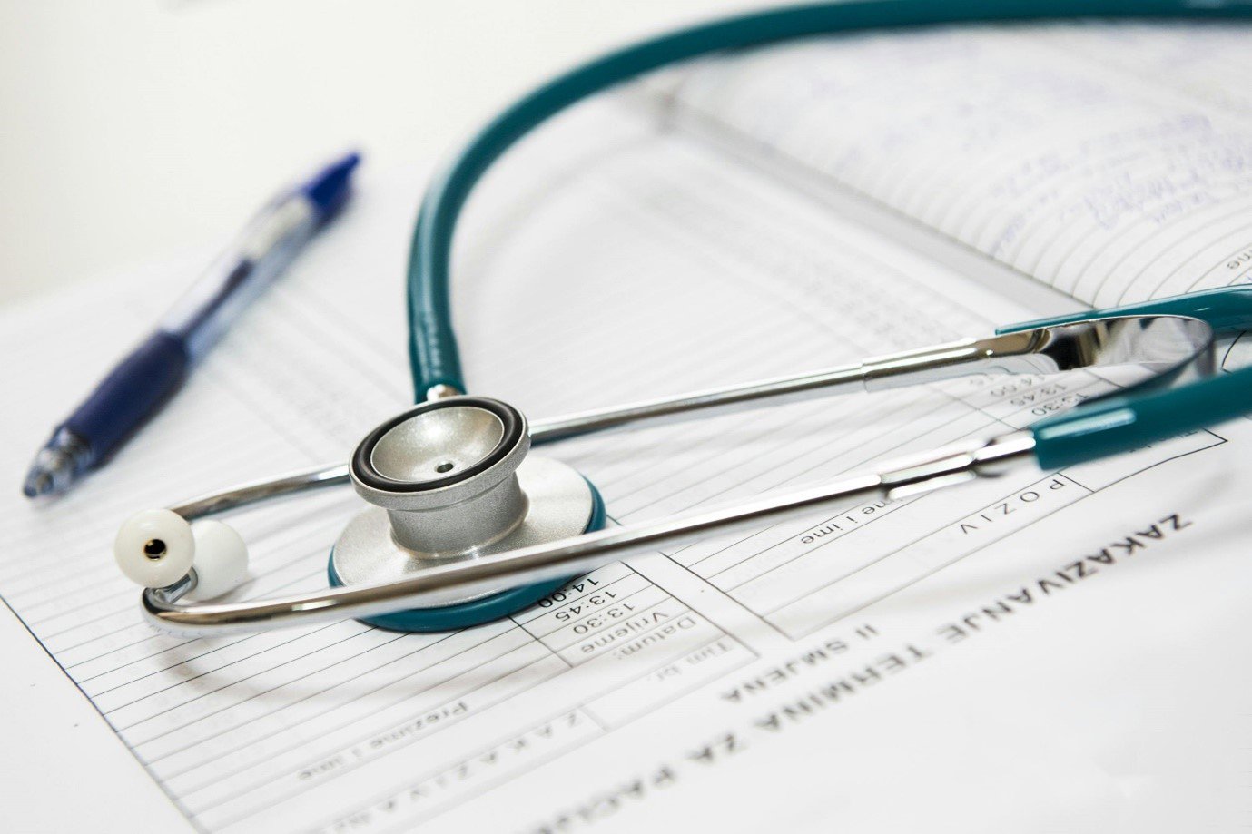 a stethoscope on top of some medical documents