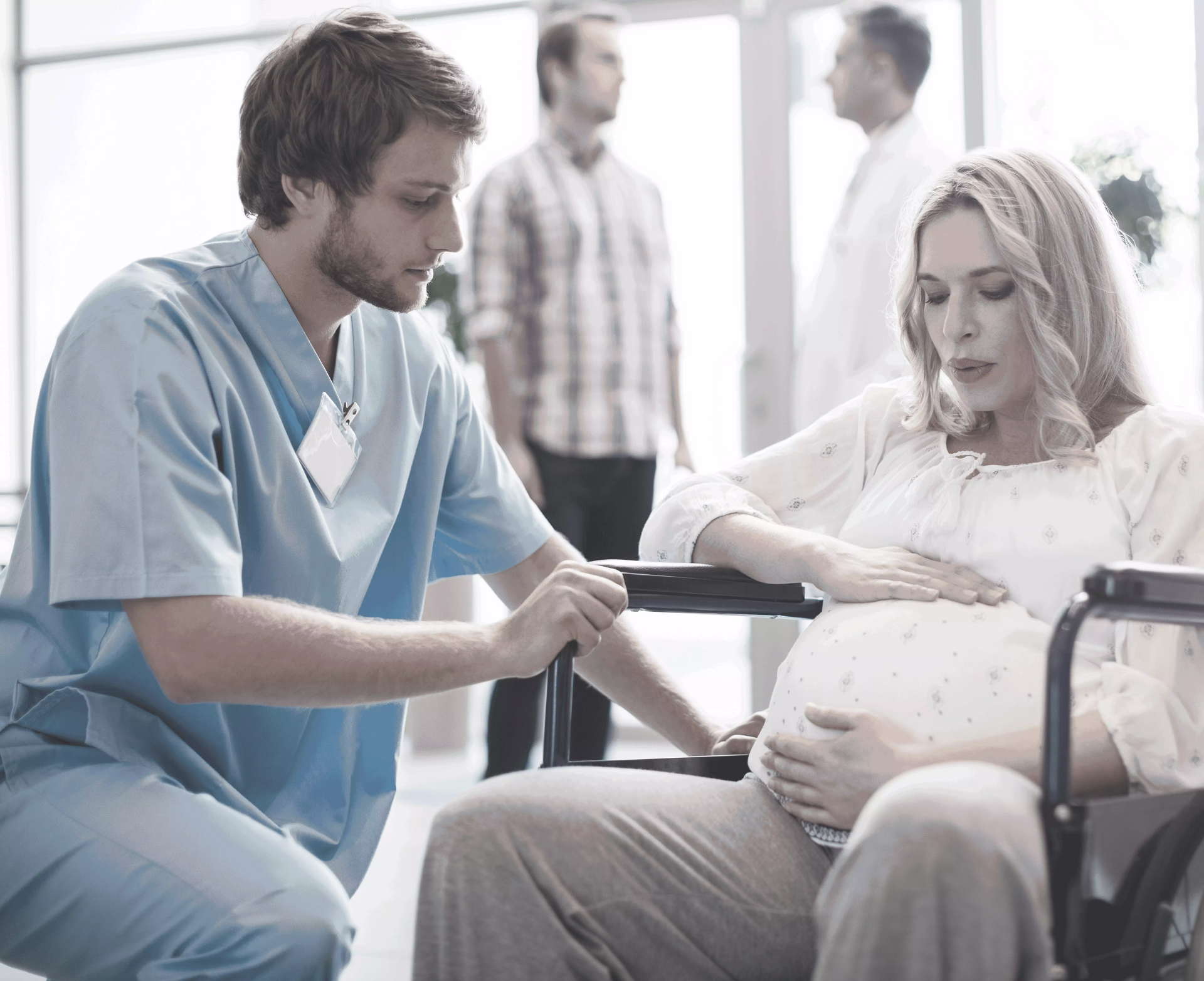 a pregnant woman being attended to by a nurse