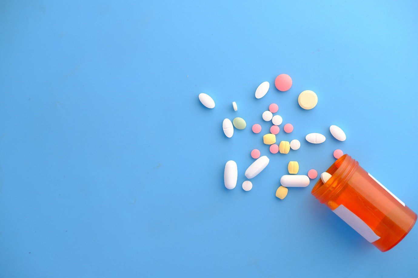 a bottle of pills on a blue background