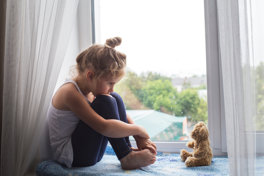 Sad Girl Sits On A Window Sill