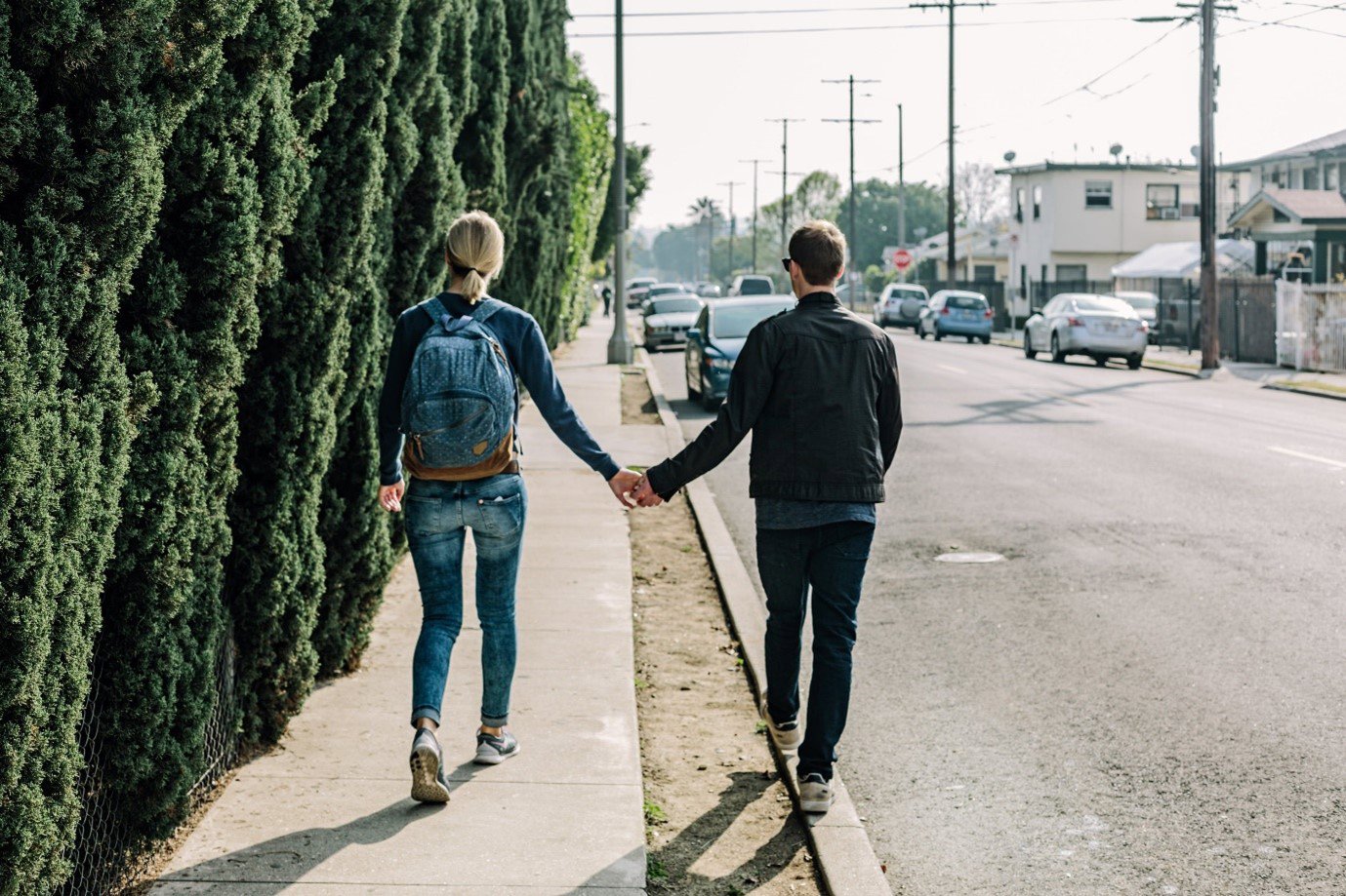 two people walking holding hands