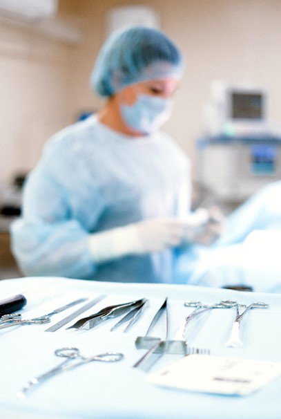 a surgeon standing near medical supplies