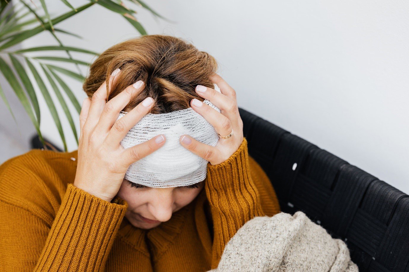 a woman with a bandage wrapped round her head