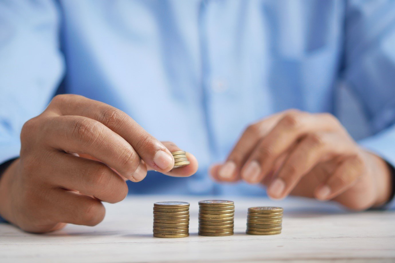 a man counting out coins into piles