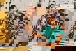 A man assisting his son with his homework