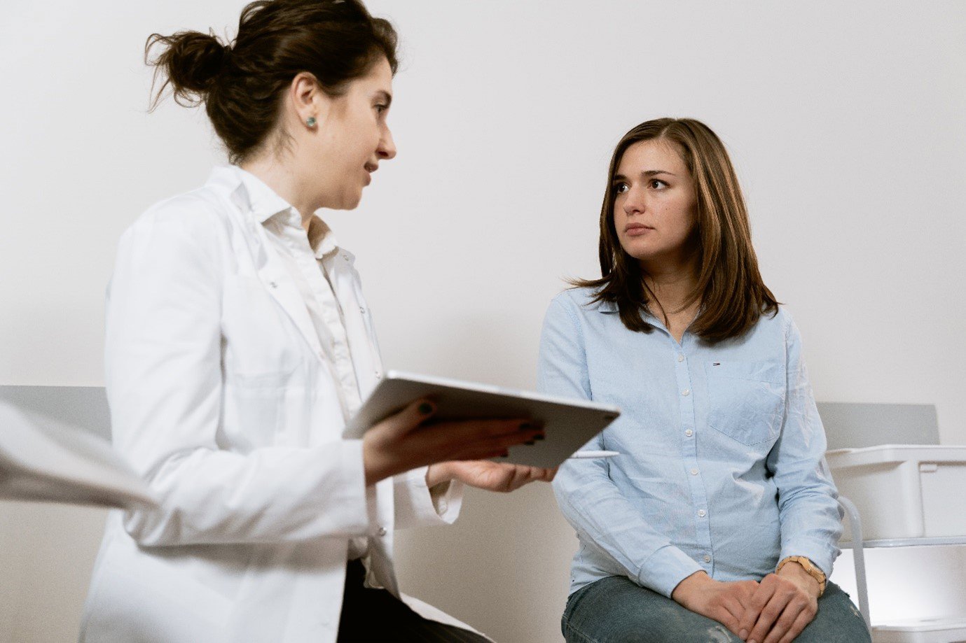 a woman speaking with a medical consultant