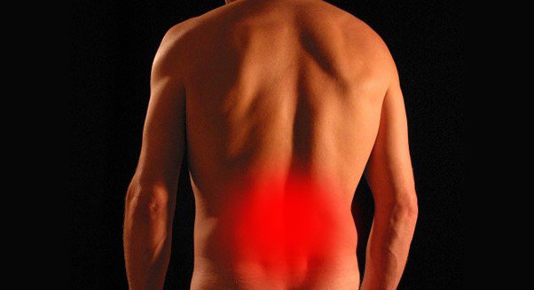 a man's back with a red mark showing a pained area