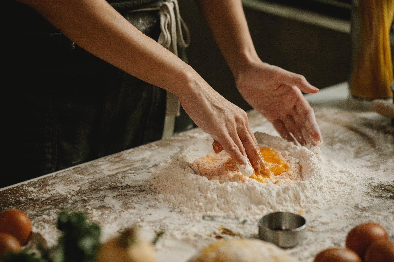 a baker mixing eggs and flour