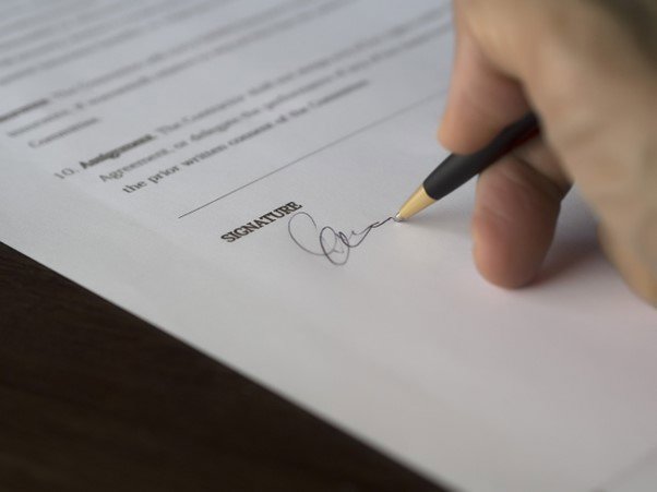 a close up of a signature being written on a piece of paper