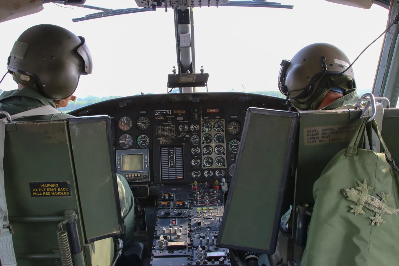 Two people in the cockpit of a helicopter