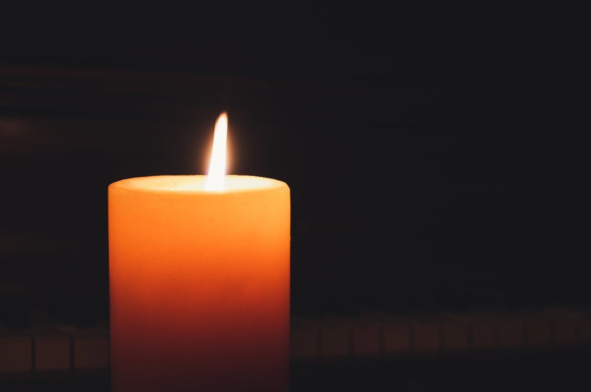 a candle on a dark background