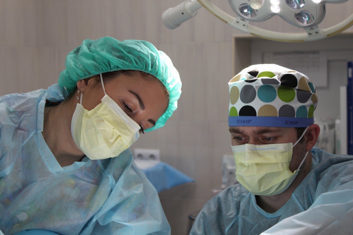 two surgeons operating on a patient