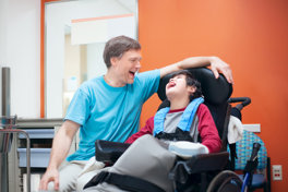 Child In Wheelchair With Parent