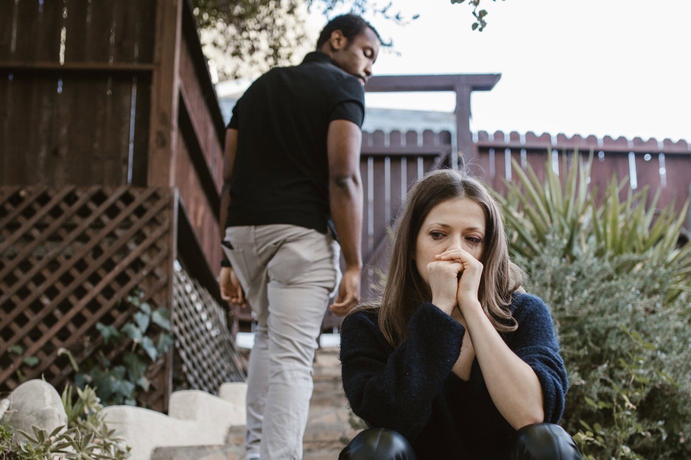 an unhappy couple in a garden