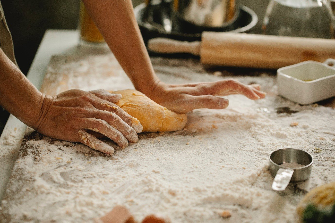 a baker rolling out dough