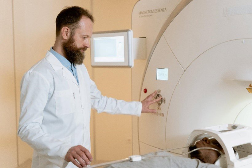 a doctor next to an mri machine