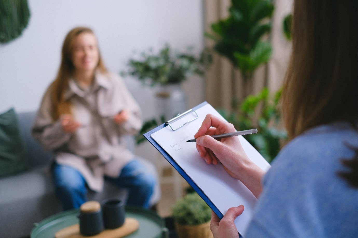 two people talking, one holds a clipboard