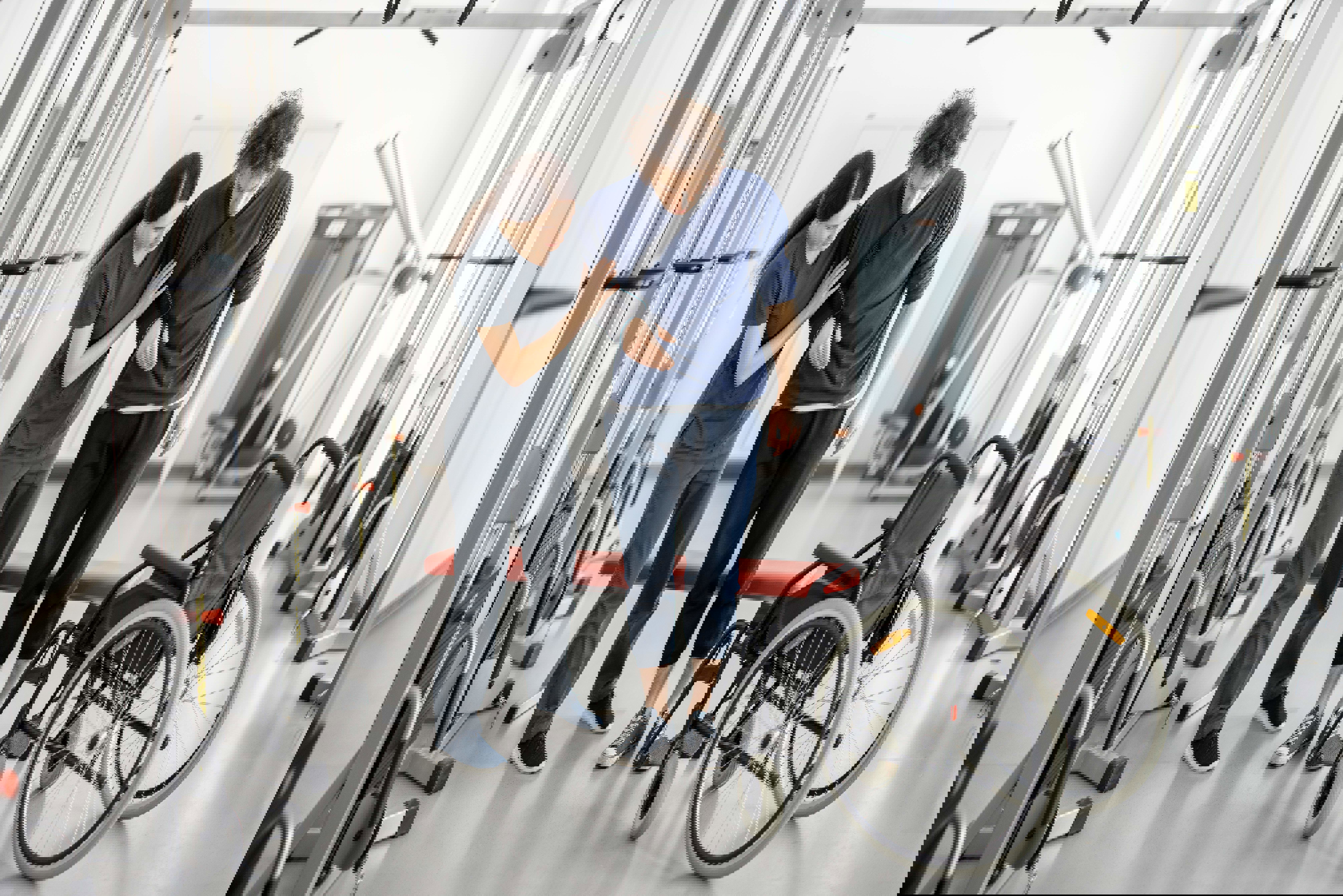 Rehabilitation Specialist helps young man out of wheelchair