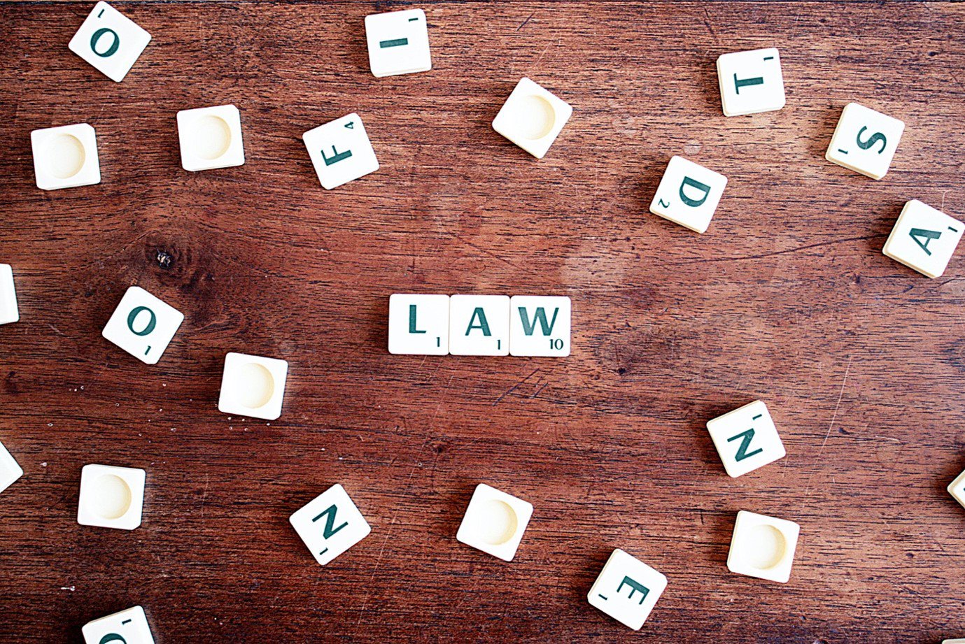 scattered scrabble tiles spelling out LAW
